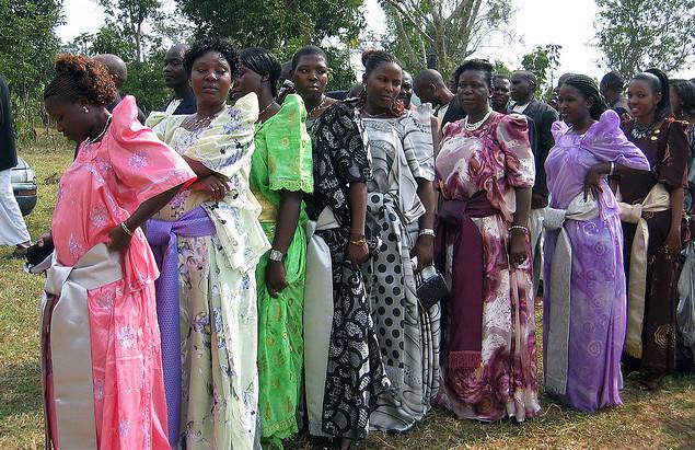 Women line up at wedding procession in Uganda. Photograph by sarahemcc.