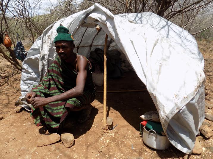 Chelanga Chebet sits outside his temporary shelter. Credit: Rachel Muthoni.