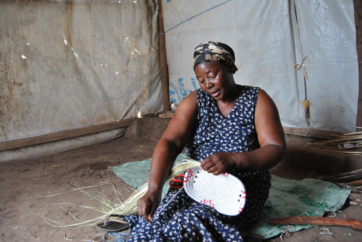 Ndikuriyo weaving a basket at her house in Kalobeyei, Kakuma.