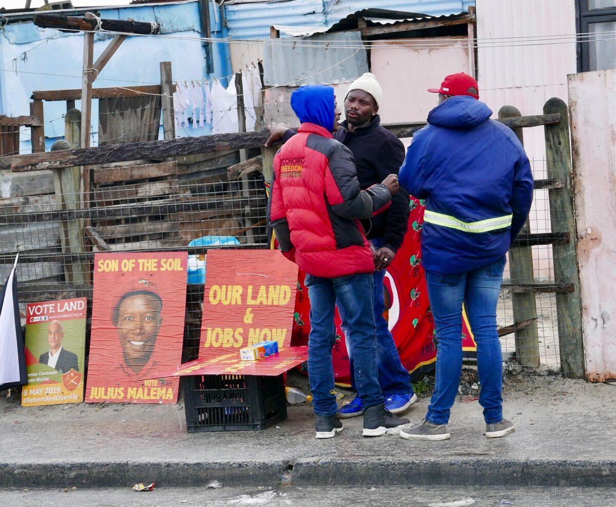 EFF supporters by party posters. Credit: Martin Plaut.