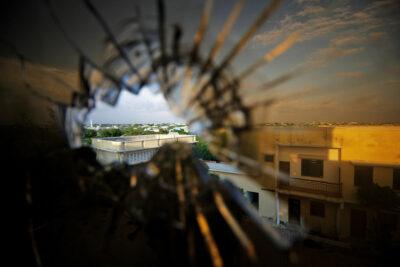 Africa war: A view of the skyline beyond the northern suburbs of Mogadishu is seen through a bullet hole in the window of a hotel in the Yaaqshiid District of Mogadishu, where African Union Mission in Somalia (AMISOM) forces have pushed Al Shabaab militants beyond the city's northern fringes to the outskirts of the Somalia seaside. Credit: UN Photo/Stuart Price.