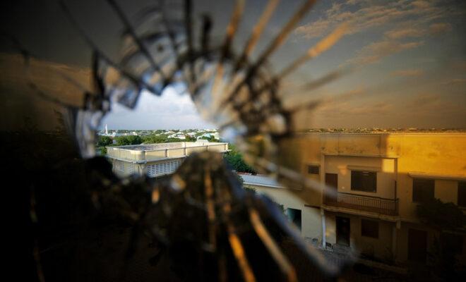 Africa war: A view of the skyline beyond the northern suburbs of Mogadishu is seen through a bullet hole in the window of a hotel in the Yaaqshiid District of Mogadishu, where African Union Mission in Somalia (AMISOM) forces have pushed Al Shabaab militants beyond the city's northern fringes to the outskirts of the Somalia seaside. Credit: UN Photo/Stuart Price.