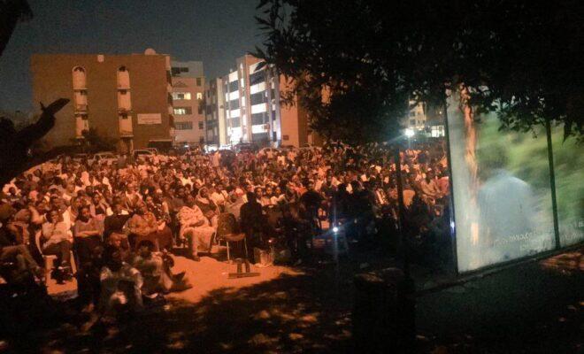 People gather for an open air film screening in Khartoum, Sudan.
