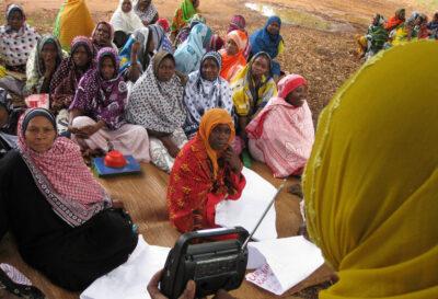 Women listen to a radio election broadcast in Zanzibar, Tanzania. Credit: UNDP.