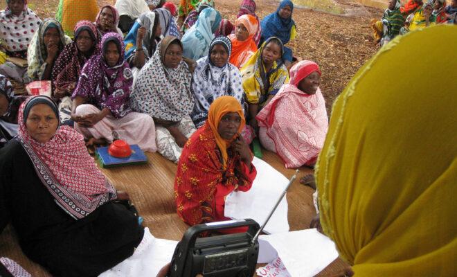 Women listen to a radio election broadcast in Zanzibar, Tanzania. Credit: UNDP.