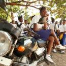 Sierra Leone pregnant school girl ban: A school girl in Sierra Leone sits on a motorcycle. Credit: GPE/Stephan Bachenheimer