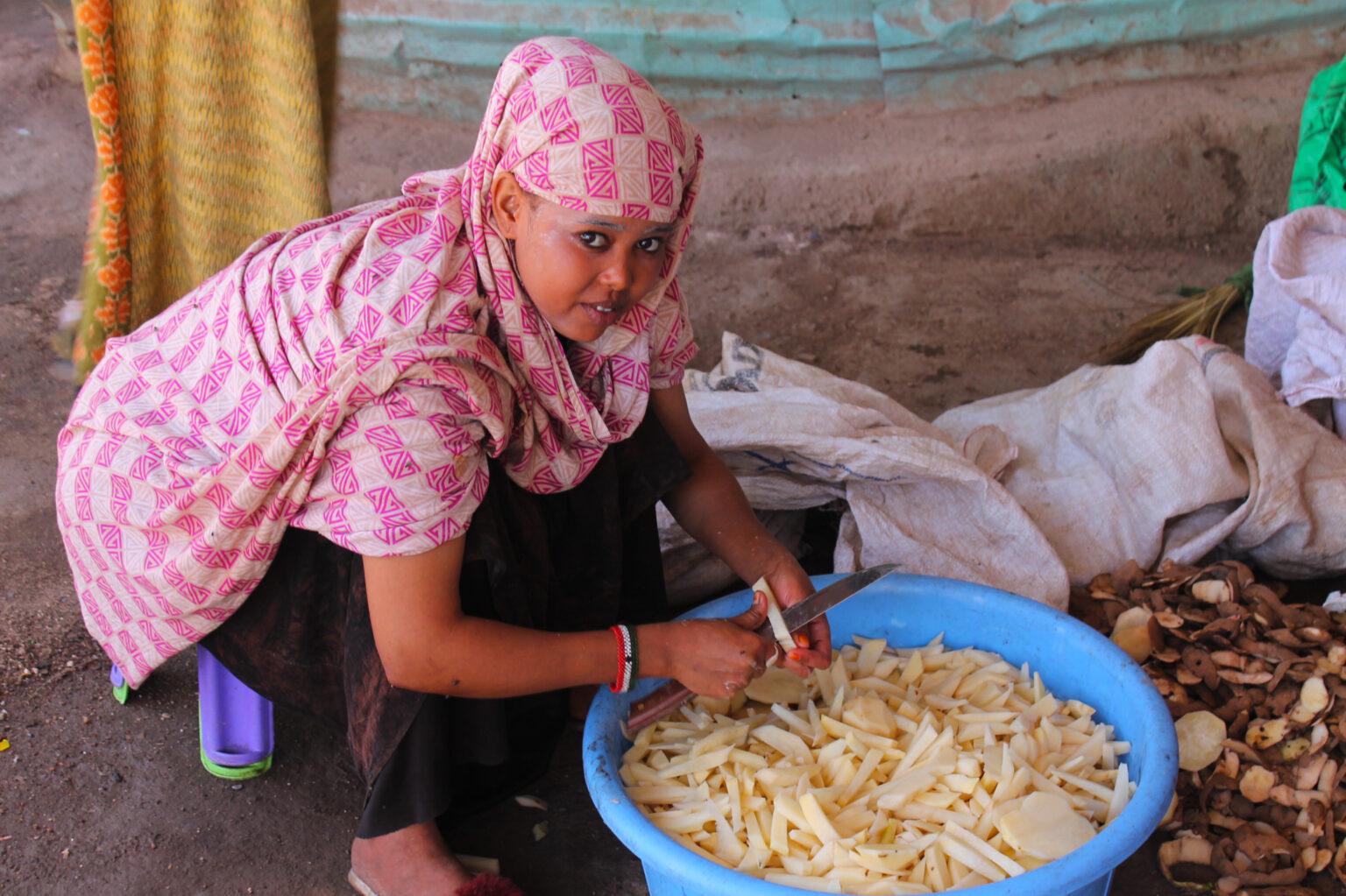 A woman prepares food for sale on the streets of Jijiga in Somali ...