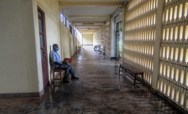 elections. A man waits in a hospital during the COVID-19 pandemic in Tanzania. Credit: Edith Macha.
