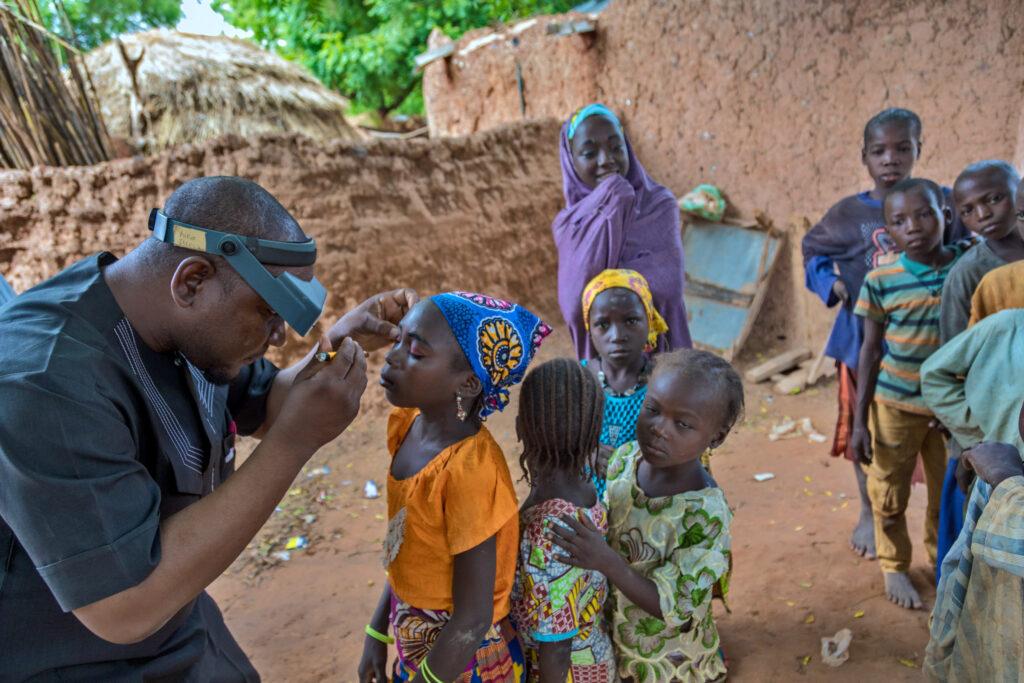 Suraju an ophthalmic nurse screens eyes of children in Sokoto State, North-west Nigeria in 2019. The work was supported through the Ascend programme. Credit: Andrew Esiebo/ Panos pictures/ Sightsavers.