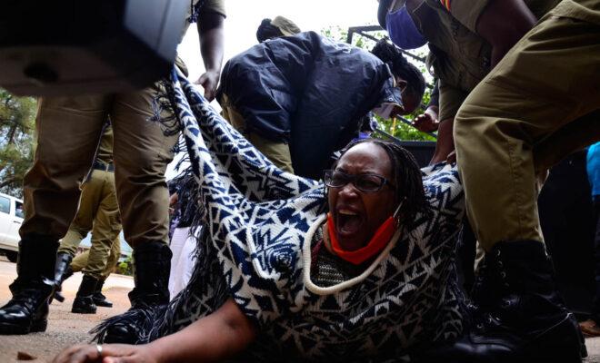 Female police officers drag prominent Stella Nyanzi to a police van in Kampala in May 2020. Credit: Abubakar Lubowa/Ugandan Press Photo Award (UPPA).