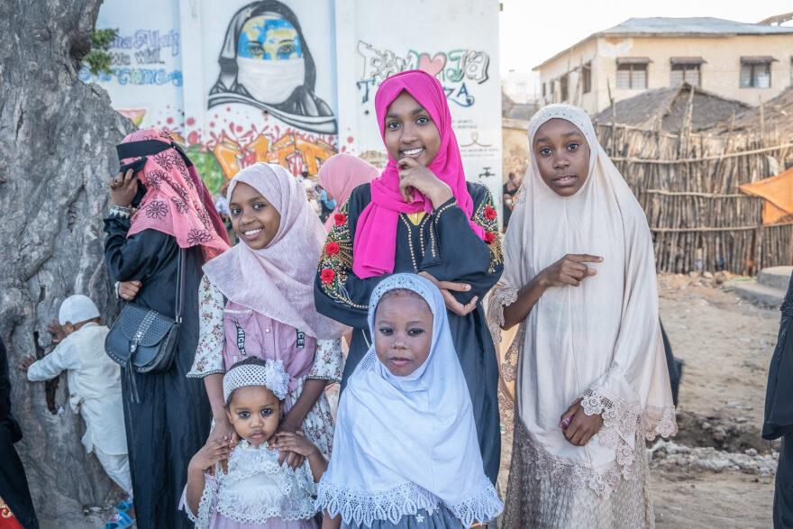 A group of young girls, dressed in their best outfits, await the procession of worshippers who will pass the seafront from Swaleh’s graveyard back to Riyadha Mosque.