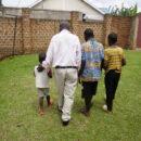 Abubaker walks with three of his kids. He had a vasectomy in secret because he decided it was time to stop having children. Credit: Edna Namara/Global Press Journal.