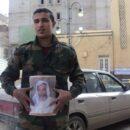 A man in Benghazi holds a picture of King Idris in the midst of the Libyan Uprising in 2011. Credit: Maher27777