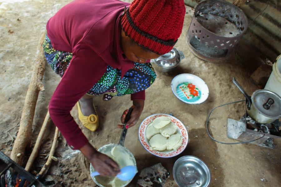 Mary Phiri prepares a maize porridge, known locally as nshima, at her home in Rufunsa, Zambia, on July 18, 2022. It is her only meal of the day before she takes her antiretroviral medication for HIV. Credit: Prudence Phiri/GPJ.