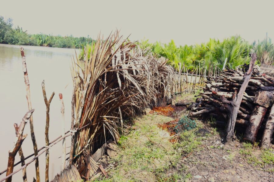 A makeshift embankment offers meagre protection to a house. Credit: Ekpali Saint.