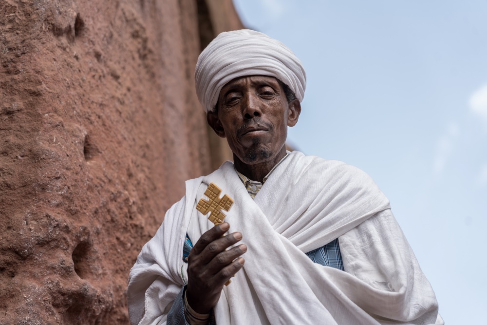 Father Gebez Abeba Sisay says water leaks inside Biete Qeddus Mercoreus and the cracks in its walls and ceiling are widening in Lalibela. Credit: Jaclynn Ashly.