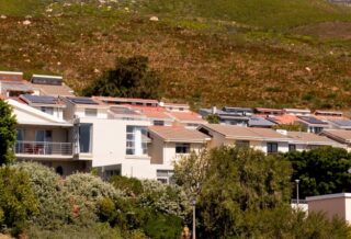 Solar panels dot the rooftops of several houses in Vredehoek, Cape Town, South Africa. Credit: Julie Bourdin.