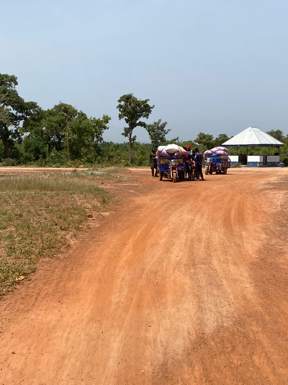 Motorised tricycles carrying goods arrive at a border checkpoint in Ghana's Upper West region. Author's photo.